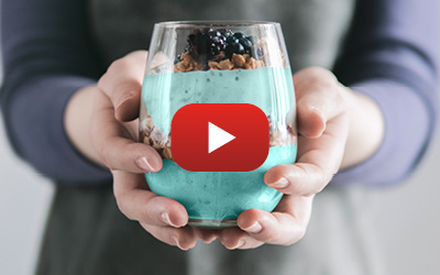 Hands holding a blue bedtime drink